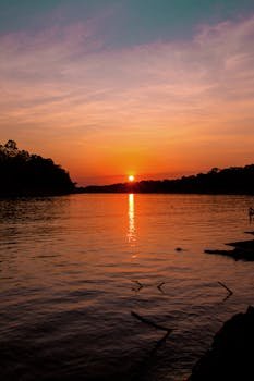 Beautiful sunset over the Amazon River with vibrant colors and tranquil waters.